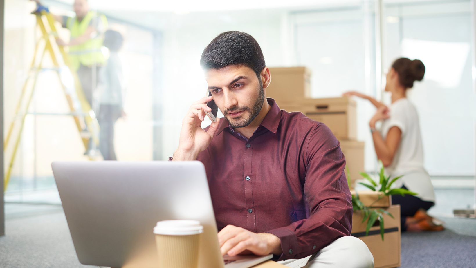 business man talking on phone during office move